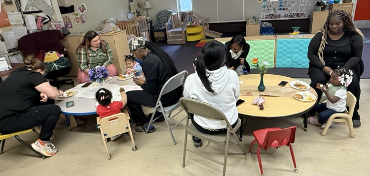 photo of kids and mother sitting at the table 