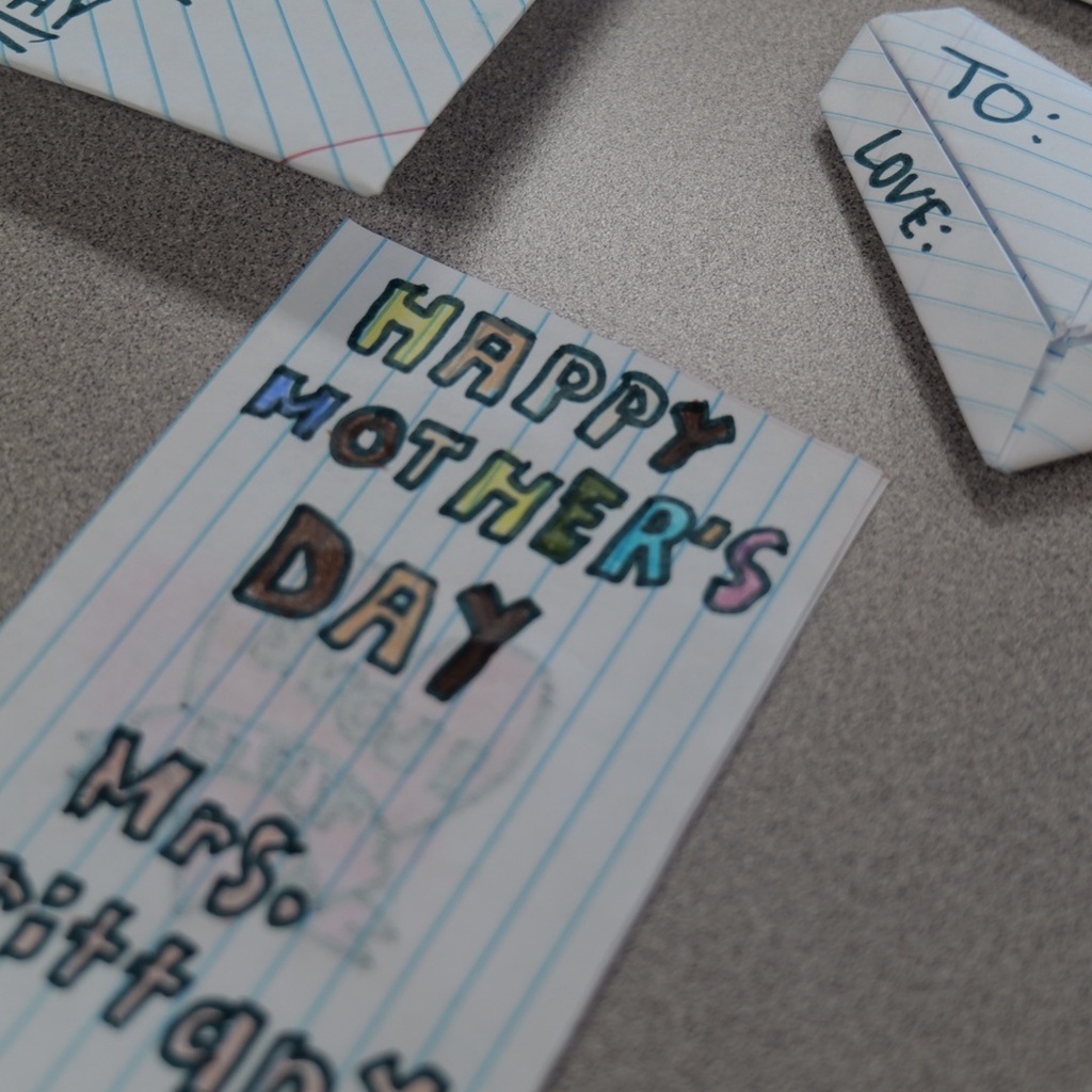 Handwritten cards with colorful text, "Happy Mother's Day" and "To: Love," and an envelope.