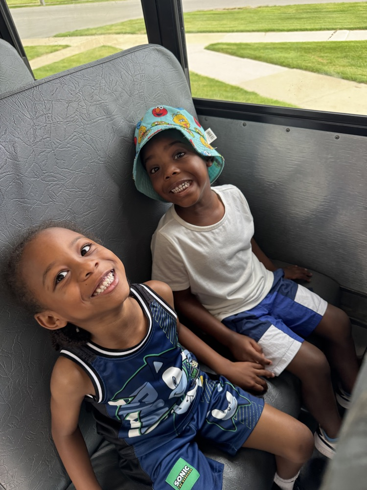 two children sitting on the bus