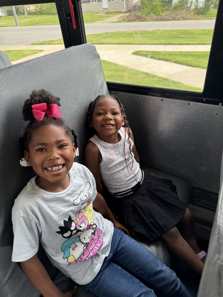 two children sitting on the bus