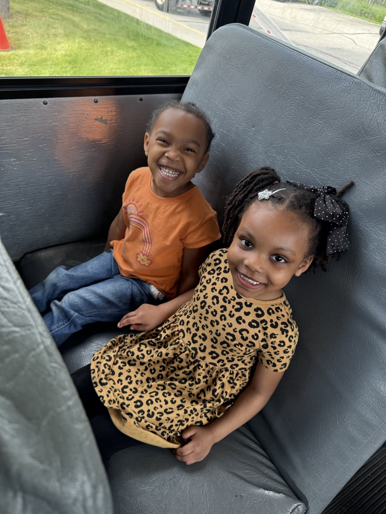 two children sitting on the bus