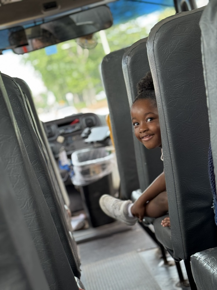 child looking over bus seat