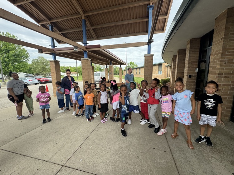 children outside school building 