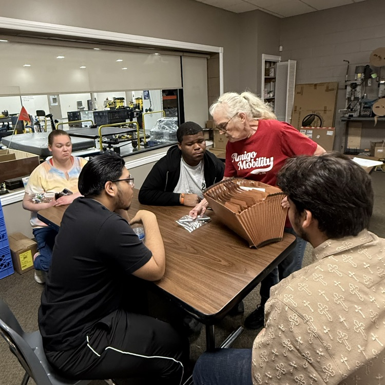 Jamie talking with students at Amigo Mobility.