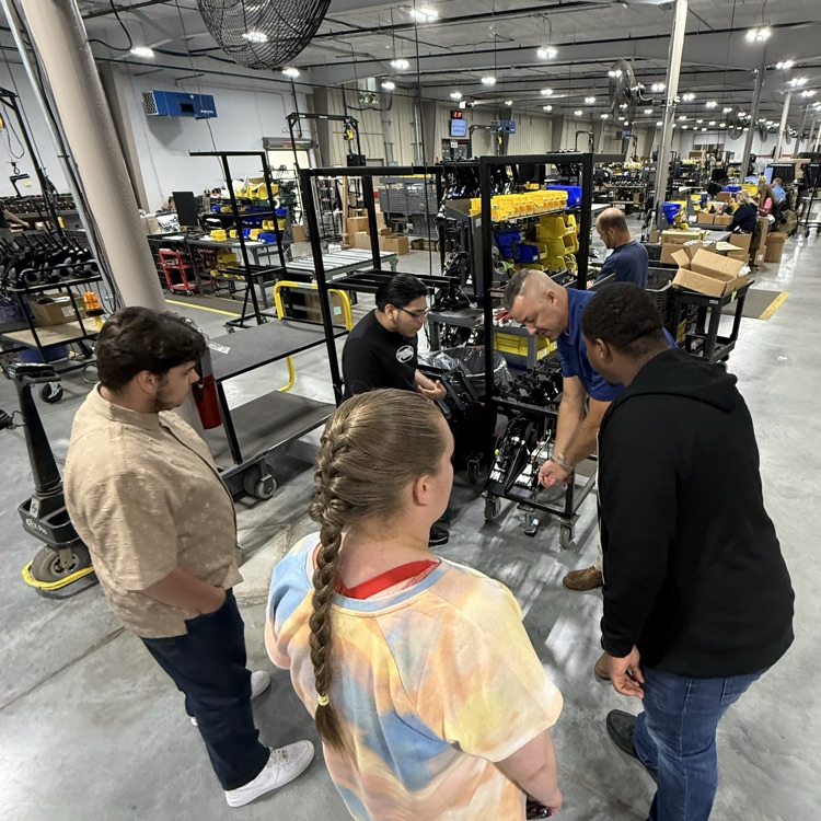 Tim giving students a tour and showing them some of the work tasks they will be completing this summer.
