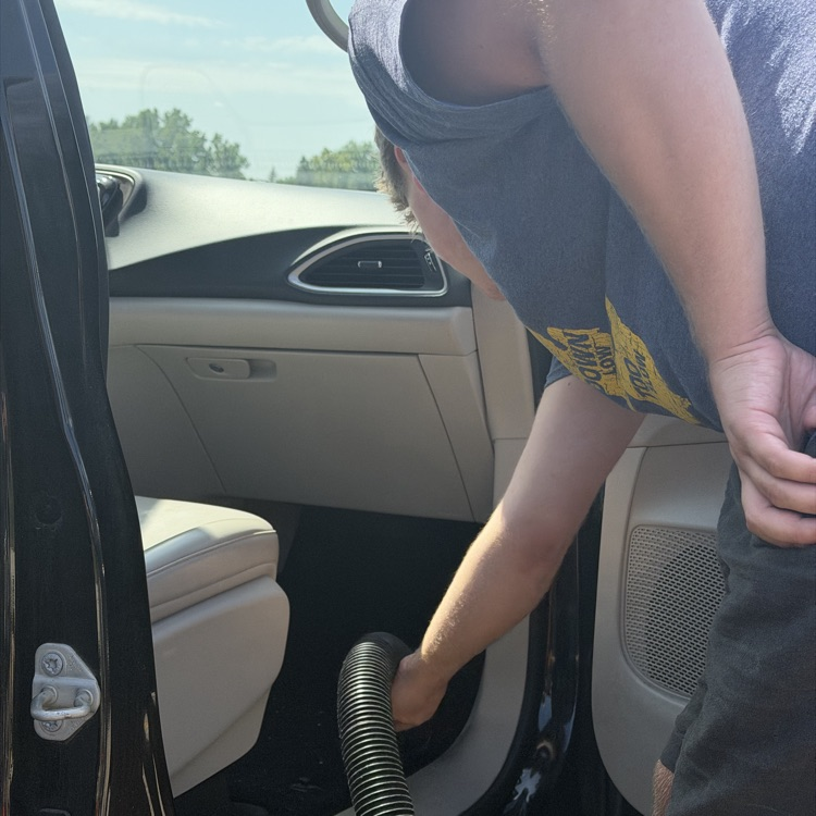 Students vacuum Van 5 at Millet Learning Center