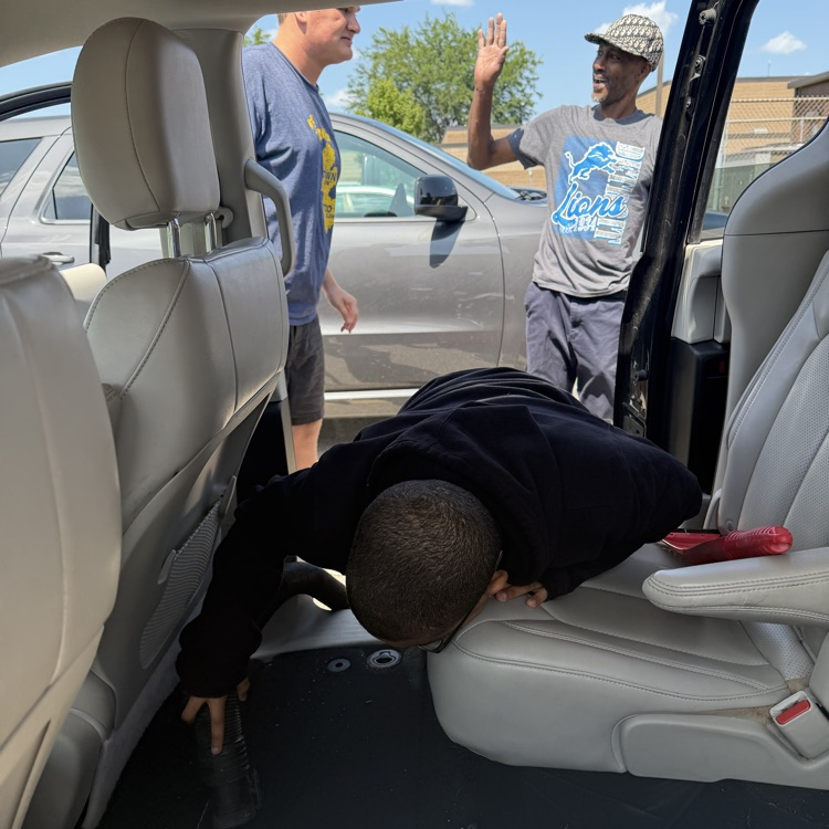 Students vacuum Van 5 at Millet Learning Center