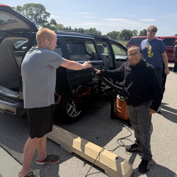 Students vacuum Van 5 at Millet Learning Center