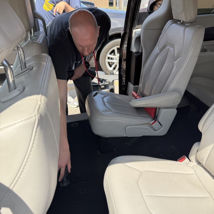 Students vacuum Van 5 at Millet Learning Center
