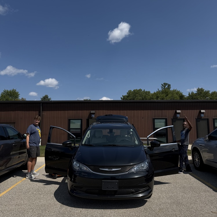 Students vacuum Van 5 at Millet Learning Center