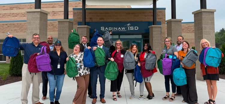 superintendents at student backpack donation