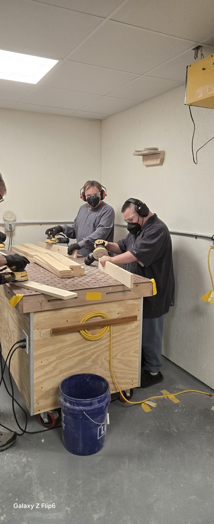 Two students sanding
