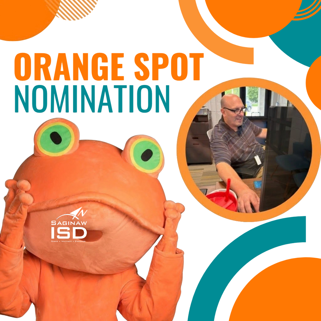 A mascot dressed in an orange frog costume. A man in a plaid shirt sits at a computer.