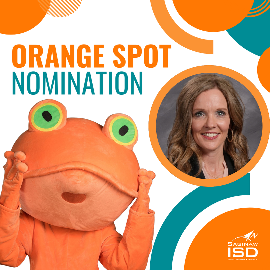 A mascot in an orange frog costume holds its face up. A smiling woman in a black top.