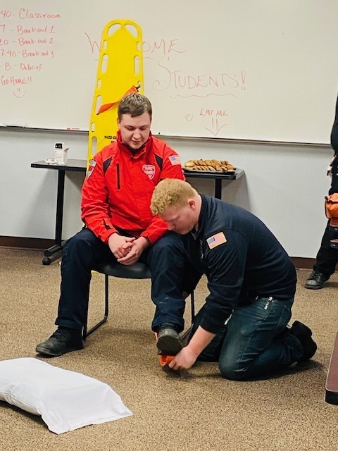Two MMR professionals showing how to splint an ankle