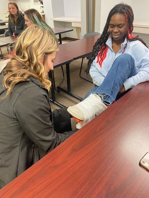 two students practicing on how to splint an ankle