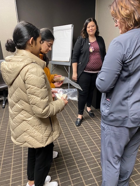 two students with two nurses