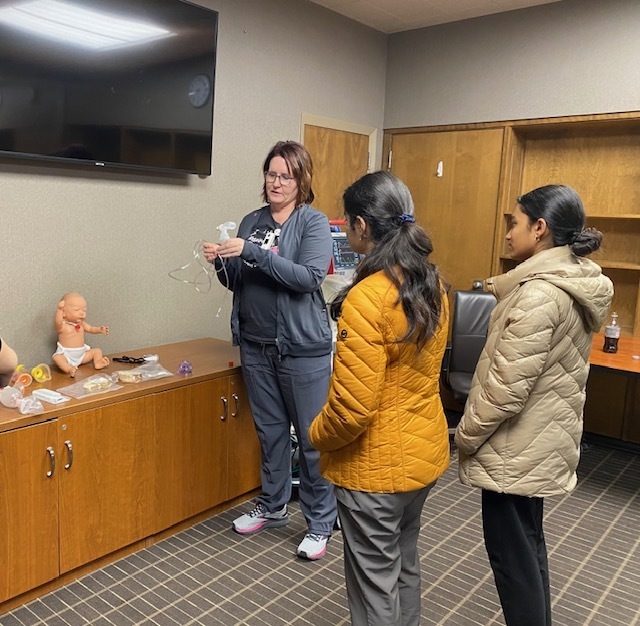 two students with nurse instructor who is showing IVs