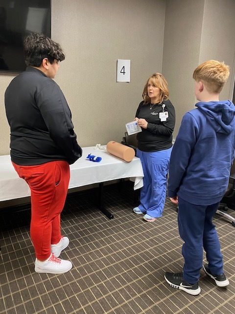 Nursing showing two male students wound care techniques
