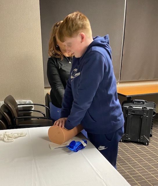one male student performing wound care application