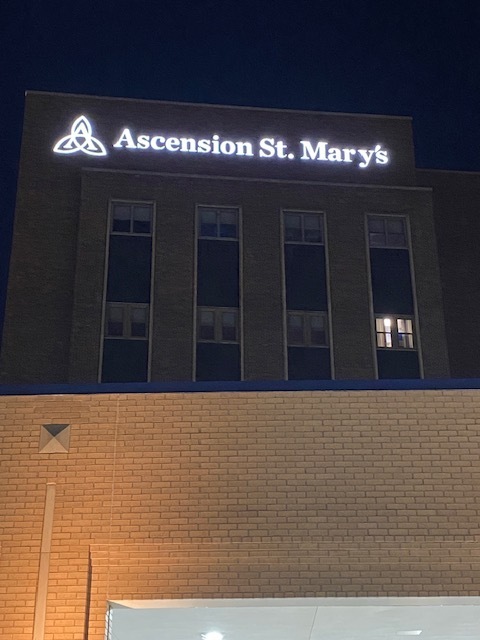 Asecension St. Mary's Sign Lit up in the dark sky