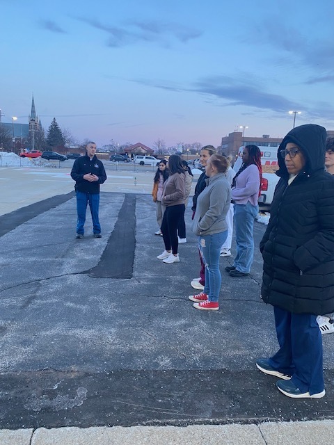 students outside speaking to a flightcare crew person