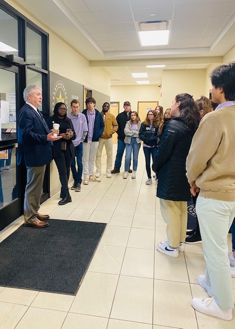 Saginaw County Sheriff speaking to student ambassadors in the lobby