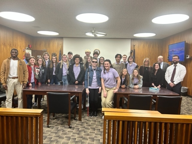 Student ambassadors inside the courtroom with public officials