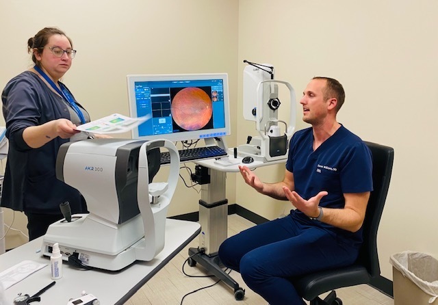 Two GLBH staff members talking about vision services