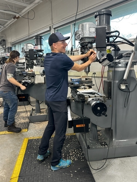 male student using a manual lathe