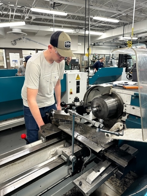Male student working on a mill