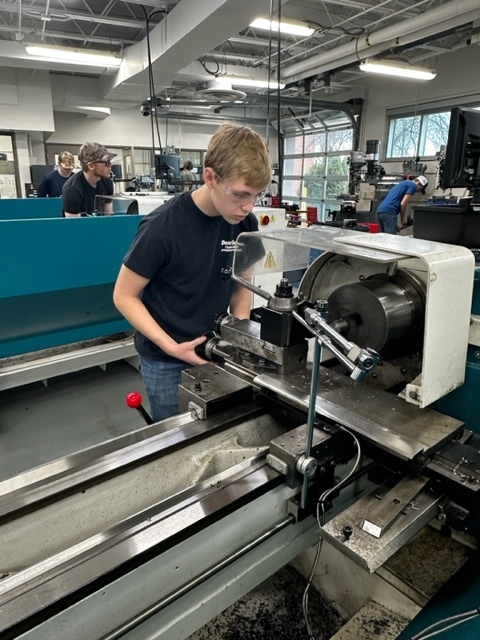 Male student working on a mill