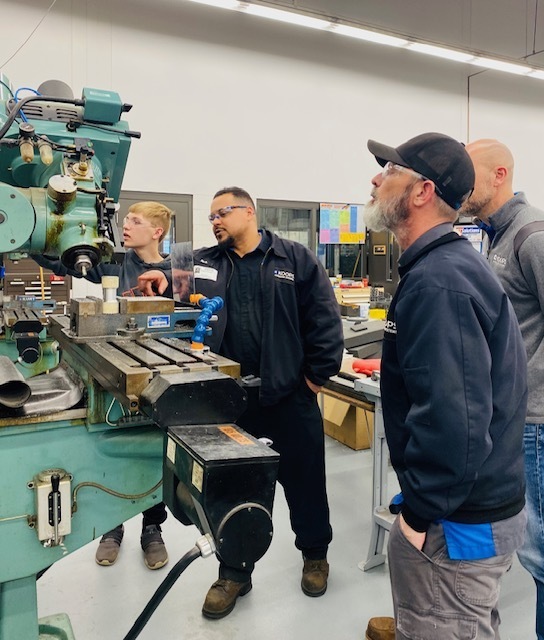 The team members from Koops were interested in what Aiden knows about milling