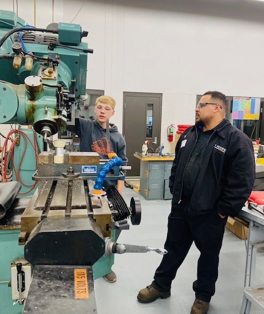 A male student from Chesaning shows off his skills on the manual lathe