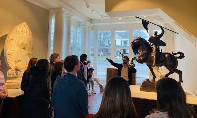 Students inside the saginaw art museum looking at a sculpture