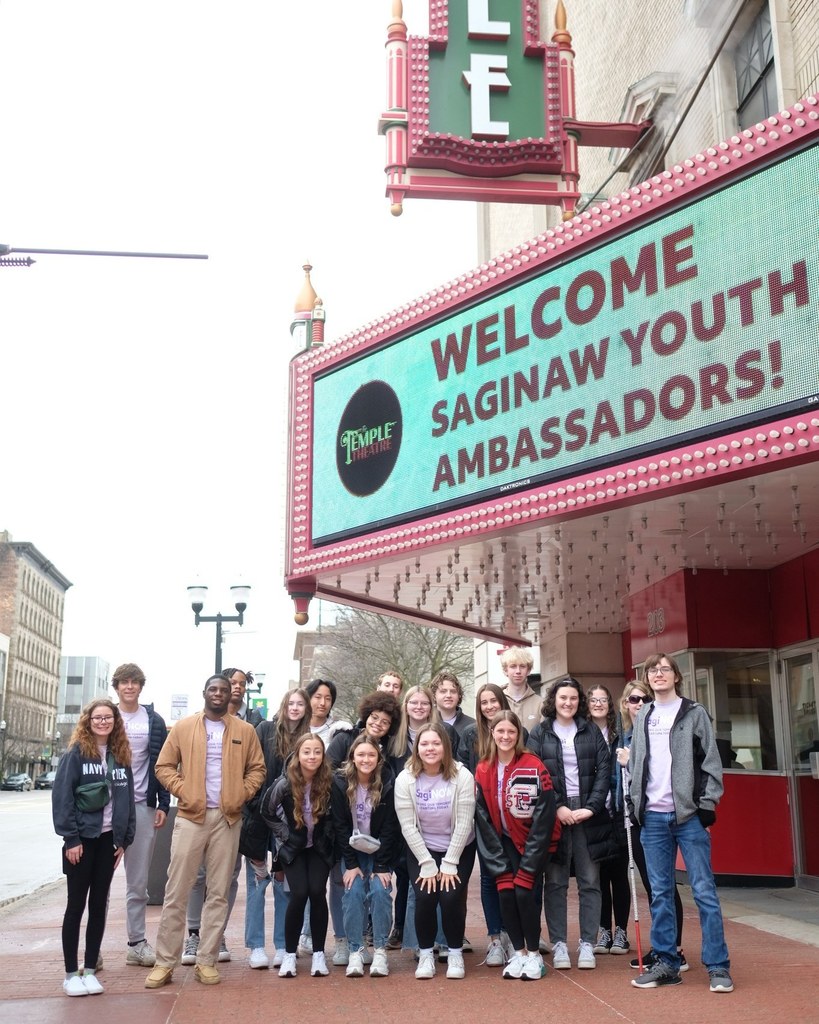 Cohort 3 Youth Ambassadors in front of Temple Sign