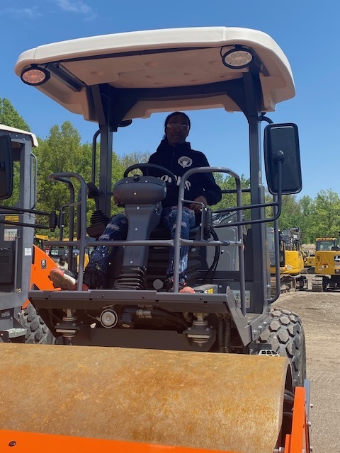 Student sitting inside and pretending to operate a piece of AIS equipment