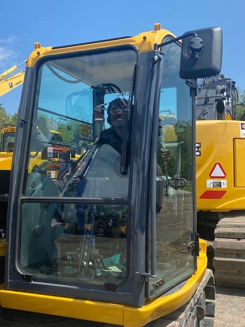 Student is inside the cab of one of the AIS machines