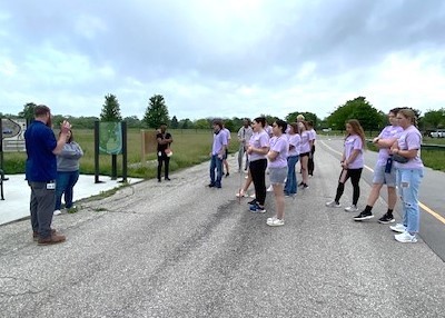 Student ambassadors listening to two park representatives talking about the park and rec system in Saginaw County