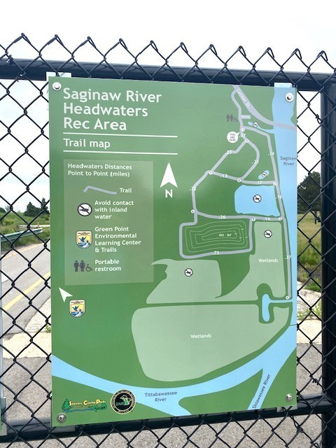 Saginaw River Headwaters Rec Area signage which includes a map showing the water and walking trails