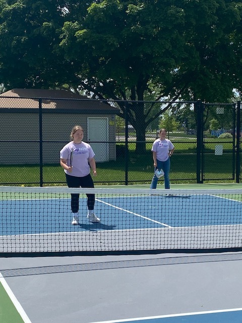 two female students playing pickleball