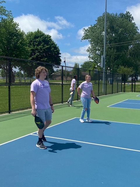 Male andfemale student playing pickleball