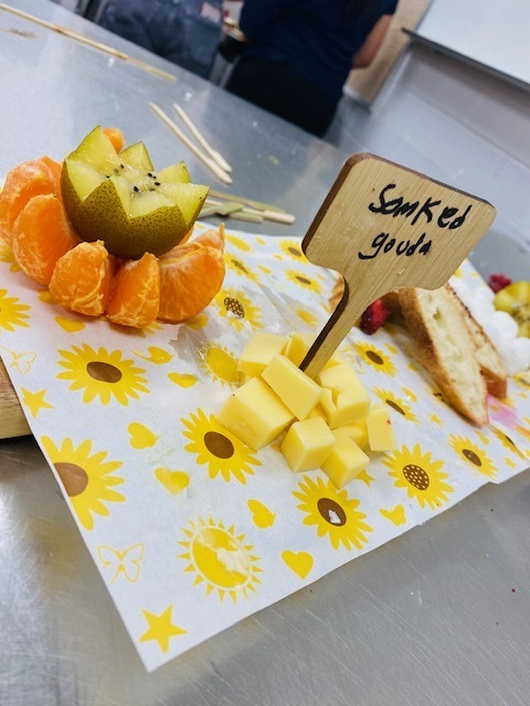 cheese and fruit board with a sign that says "smoked gouda"