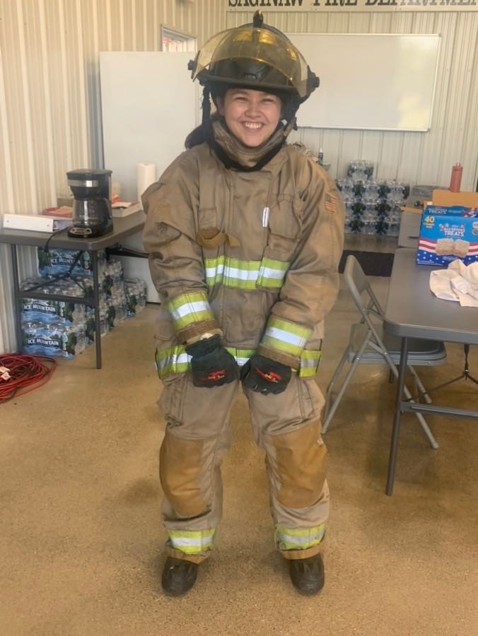 Junior firefighter student all smiles in full firefighter gear