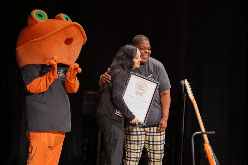 hugging people on stage
