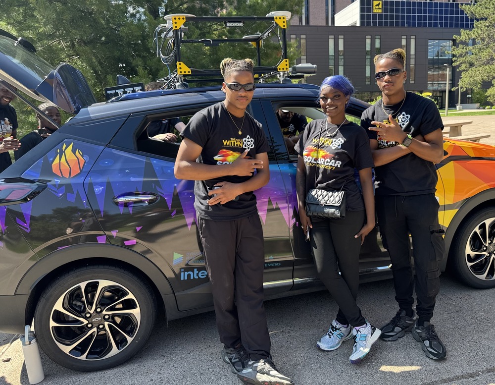 Students standing by vehicle