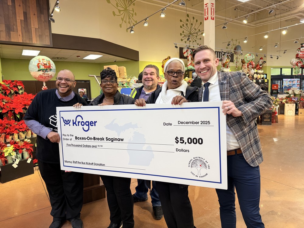 People posing with big check
