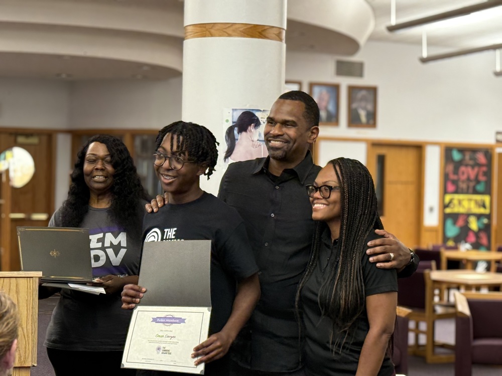 Student accepts certificate at celebration