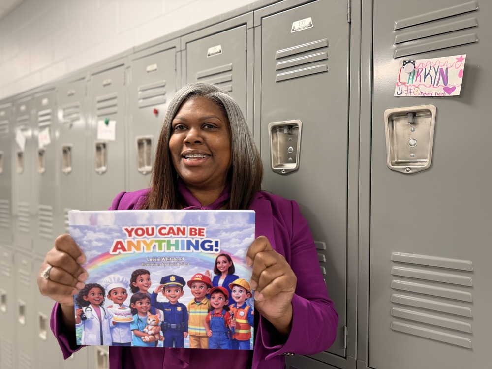 Laticia Whitehead holding childrens book