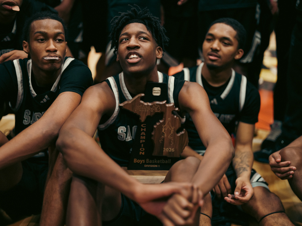 Saginaw United basketball team with district championship trophy